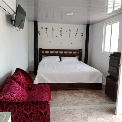 a bedroom with a bed and a couch at Dulce Barú in Ararca