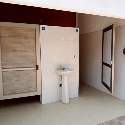 a bathroom with a white sink and a door at Dulce Barú in Ararca