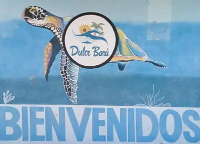 a sign with a picture of a dolphin and the words bermuda at Dulce Barú in Ararca