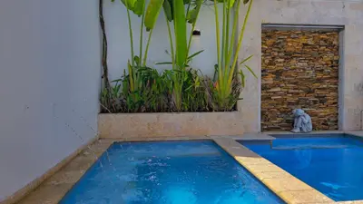 a swimming pool in the middle of a house at Spectacular Villa Near Walled City in Cartagena de Indias