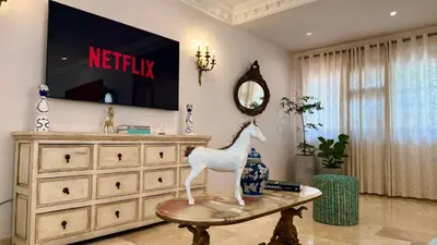 a room with a television and a statue of a horse on a table at Spectacular Villa Near Walled City in Cartagena de Indias
