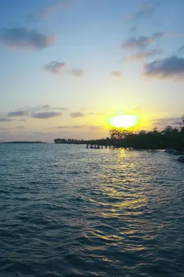 a sunset over a large body of water at Villa Luz Coastal Sanctuary in Tintipan Island
