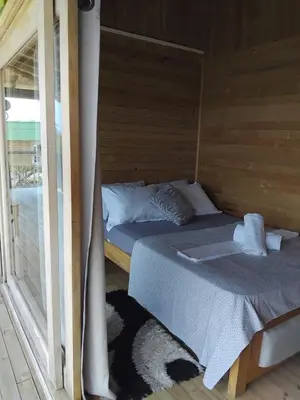 a pair of beds in a room with a window at Villa Luz Coastal Sanctuary in Tintipan Island