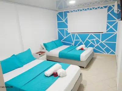 a bedroom with two beds and a blank screen at comodo apto marbella b17 in Cartagena de Indias