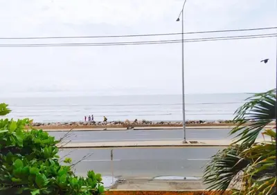 a view of the beach with people walking on the beach at comodo apto marbella b17 in Cartagena de Indias