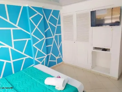 a bedroom with a blue and white wall at comodo apto marbella b17 in Cartagena de Indias