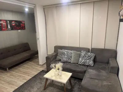 a living room with a couch and a table at New & peaceful apartment in Barranquilla