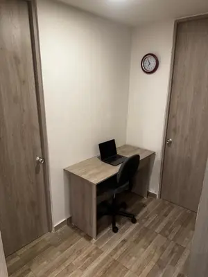 a desk with a laptop computer on it in a room at New & peaceful apartment in Barranquilla