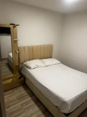 a bed in a room with a mirror next to it at New & peaceful apartment in Barranquilla