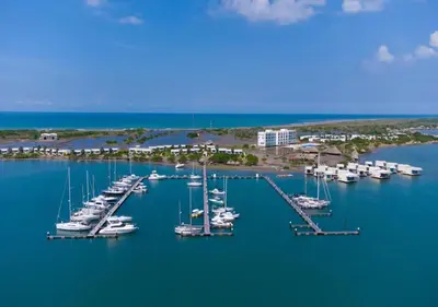 a group of boats are docked in a harbor at Marina Puerto Velero, Villa frente al Mar in El Morro