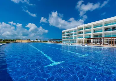 a large swimming pool in front of a building at Marina Puerto Velero, Villa frente al Mar in El Morro