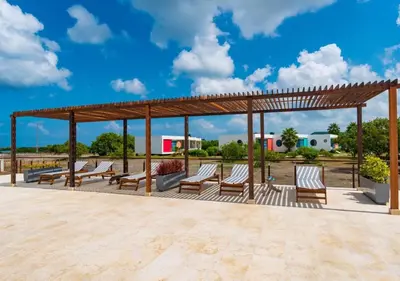 a wooden pavilion with chairs and benches on a patio at Marina Puerto Velero, Villa frente al Mar in El Morro