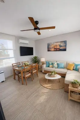a living room with a couch and a table at Marina Puerto Velero, Villa frente al Mar in El Morro