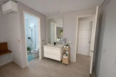a bathroom with a sink and a toilet and a mirror at Marina Puerto Velero, Villa frente al Mar in El Morro
