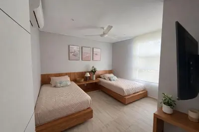 a room with two beds and a flat screen tv at Marina Puerto Velero, Villa frente al Mar in El Morro