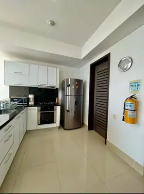 a large kitchen with a stainless steel refrigerator at 1PE-AL Apartamento de 1 alcoba frente al mar con Aire acondicionado, Piscina y Wifi in Cartagena de Indias