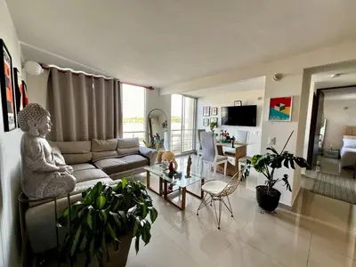 a living room with a couch and a table at Modern and cozy apartment at north in Barranquilla