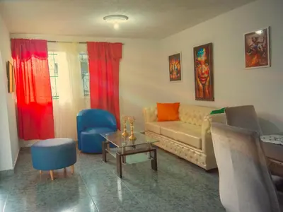 a living room with a couch and a table at Lovely and close to airport, sea, and old town in Cartagena de Indias
