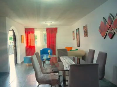 a living room with a dining table and chairs at Lovely and close to airport, sea, and old town in Cartagena de Indias