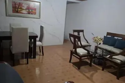 a living room with a couch and chairs and a table at Hospedaje Refugio del Caribe in Cartagena de Indias