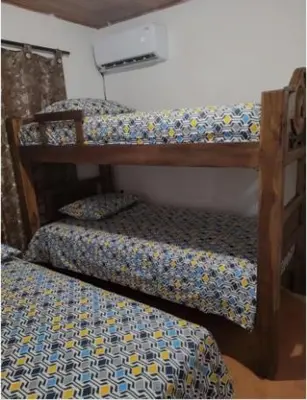 two bunk beds in a room with a bed at Hospedaje Refugio del Caribe in Cartagena de Indias