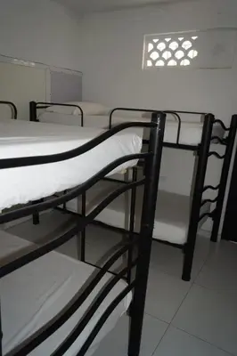 a room with two bunk beds and a table at Hotel Mar di Plata in Barranquilla