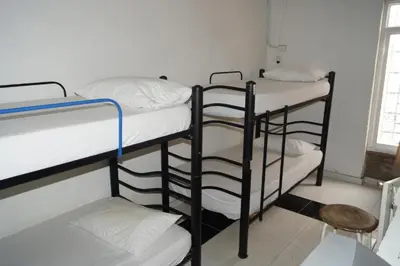 three bunk beds in a room with a window at Hotel Mar di Plata in Barranquilla