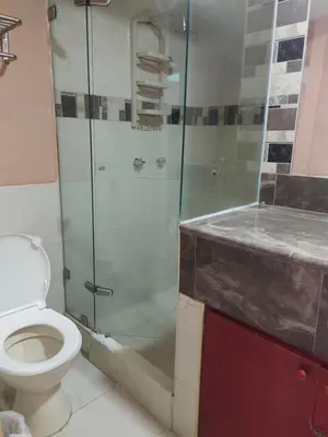 a bathroom with a toilet and a glass shower at Apartaestudio en el Laguito in Cartagena de Indias