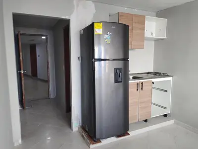 a kitchen with a stainless steel refrigerator in a room at Apartaestudio en el Laguito in Cartagena de Indias