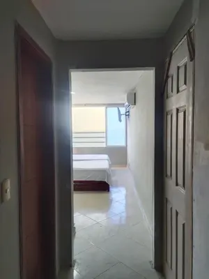a hallway with a bedroom with a bed and a door at Apartaestudio en el Laguito in Cartagena de Indias