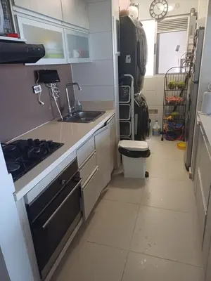 a small kitchen with a sink and a stove at Oporto in Barranquilla