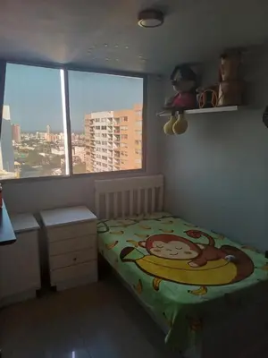 a bedroom with a monkey bed and a window at Oporto in Barranquilla