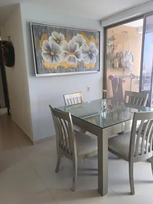 a dining room with a glass table and chairs at Oporto in Barranquilla