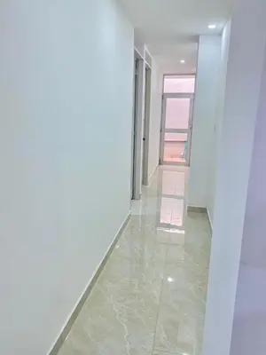 a hallway with white walls and a tile floor at Apartamento nuevo a 300 mts malecón del rio in Barranquilla