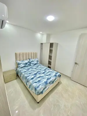 a bedroom with a bed in a white room at Apartamento nuevo a 300 mts malecón del rio in Barranquilla