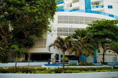 a building with palm trees in front of it at Aparamento Vista Mar 1703 in Cartagena de Indias