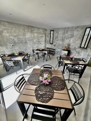 a room with tables and chairs with flowers on them at Villa pio blue in Santa Veronica