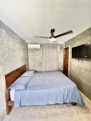 a bedroom with a bed with a ceiling fan at Villa pio blue in Santa Veronica