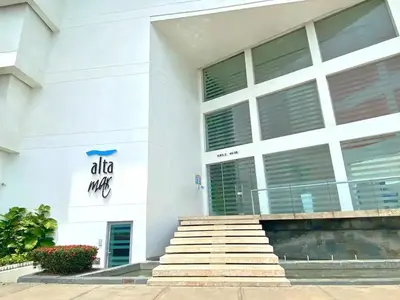 a white building with stairs in front of it at Altamar vista al mar in Cartagena de Indias