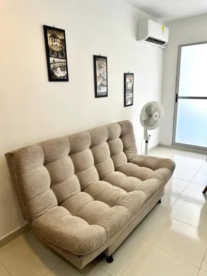 a living room with a couch in a room at Julius Sky Apartment 1-Swimming pool and close to the beach in Cartagena de Indias