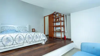 a bedroom with a bed and a wooden floor at Hermoso Pent-House Piso 21 con vista privilegiada in Cartagena de Indias