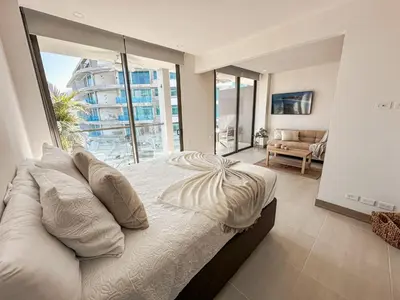 a bedroom with a bed and a large window at Apartamento Morros C28 acceso directo al Mar Manzanillo in Cartagena de Indias