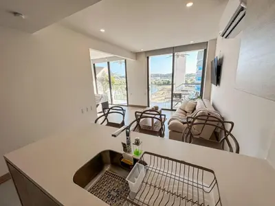 a kitchen with a sink and a living room at Apartamento Morros C28 acceso directo al Mar Manzanillo in Cartagena de Indias