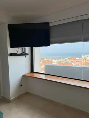 a room with a window with a view of a city at Del Mar City View in Cartagena de Indias