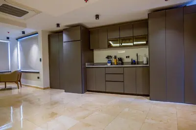 a large kitchen with brown cabinets and a table at Del Mar City View in Cartagena de Indias