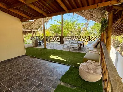 a patio with a couch and a table and chairs at Paradise BH in Maizal