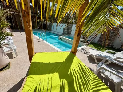a yellow and green chair next to a swimming pool at Paradise BH in Maizal