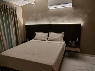 a bedroom with a large bed with a black headboard at Laureles del Parque Loft in Barranquilla