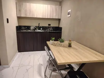 a kitchen with a wooden table with plants on it at Laureles del Parque Loft in Barranquilla