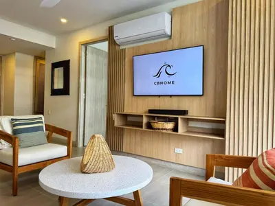 a living room with a tv on a wall at Exclusivo apartamento con Piscina Privada in Cartagena de Indias